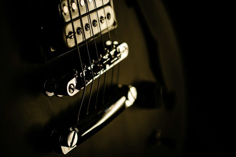 A collection of electric guitars and a bass guitar displayed together.
